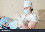 stock-photo-a-gynecologist-wears-gloves-gynecological-offic[...].jpg