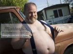 640-02769475em-overweight-man-with-suspenders-by-truck.jpg