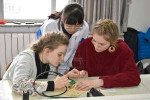 chloe-and-leah-try-their-hand-at-soldering-the-electric-cir[...].jpg