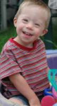 young-down-syndrome-boy-playing-in-sandpit.jpg