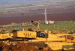 A Turkish soldier stands on top of a tank near the Turkish-[...].jpg